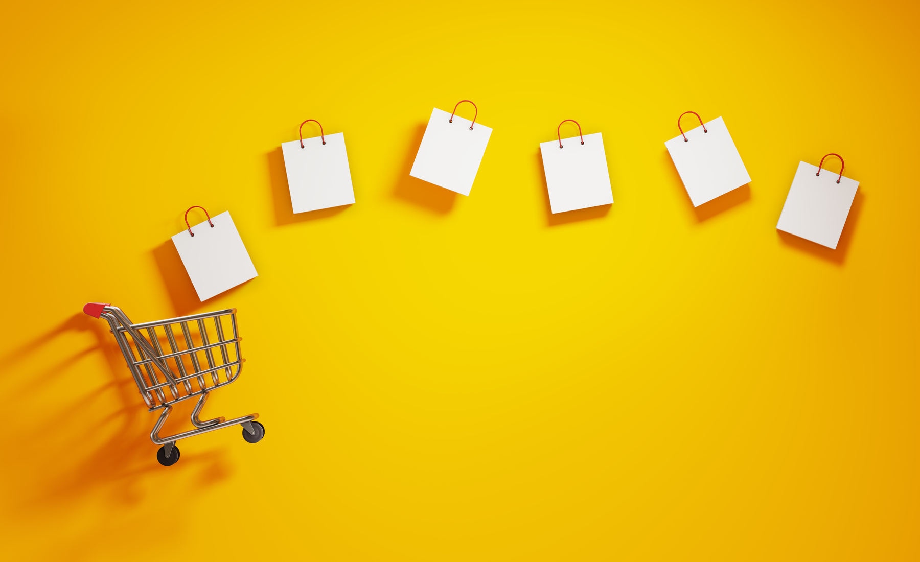 Shopping Concept- Shopping Bags And A Shopping Cart On Yellow Background